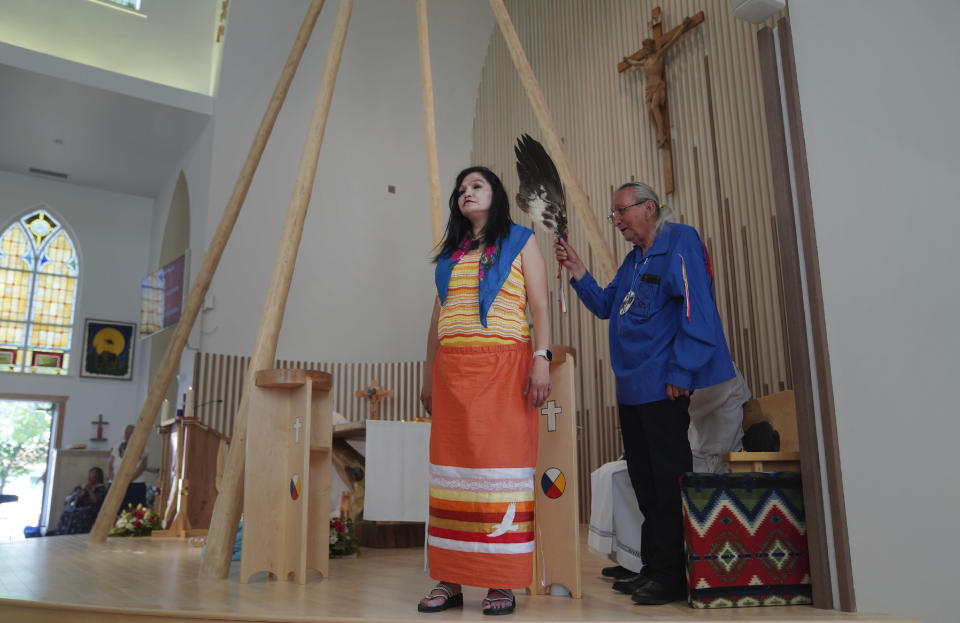 Church elder Fernie Marty gives ceremonial blessing to parishioners at Sacred Heart Church of the First Peoples on Sunday, July 17, 2022, in Edmonton, Alberta. Marty is a survivor of a day school for Indigenous children, which had culturally repressive policies similar to that of residential schools. He has continued practicing his Catholic faith in conjunction with Indigenous ceremonies. (AP Photo/Jessie Wardarski)