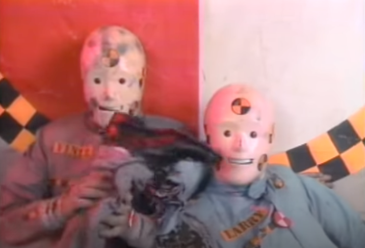 Two people in crash test dummy costumes for a demonstration or event