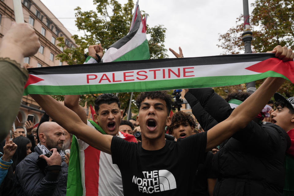 Protesters hold flags and shout slogans gather for a pro-Palestinian rally in Rome, Saturday, Oct. 21, 2023. (AP Photo/Gregorio Borgia)