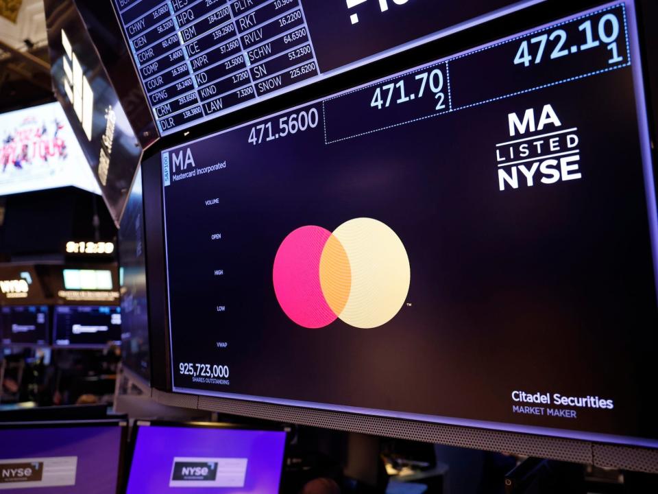 The Mastercard logo on a New York Stock Exchange screen.