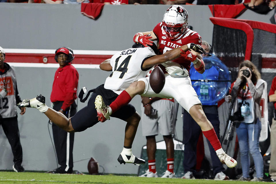 Wake Forest's Evan Slocum (14) is called for interference of North Carolina State's Thayer Thomas (5) during the first half of an NCAA college football game in Raleigh, N.C., Saturday, Nov. 5, 2022. (AP Photo/Karl B DeBlaker)
