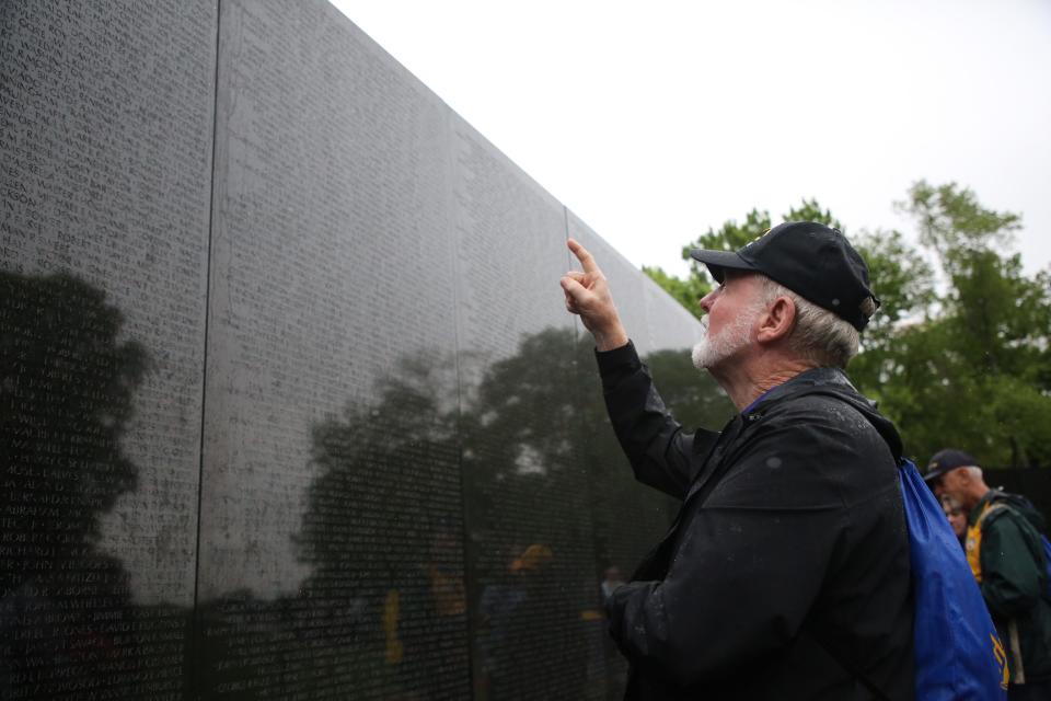 A veteran searches for a name at the Vietnam War Memorial, April 27, 2024.