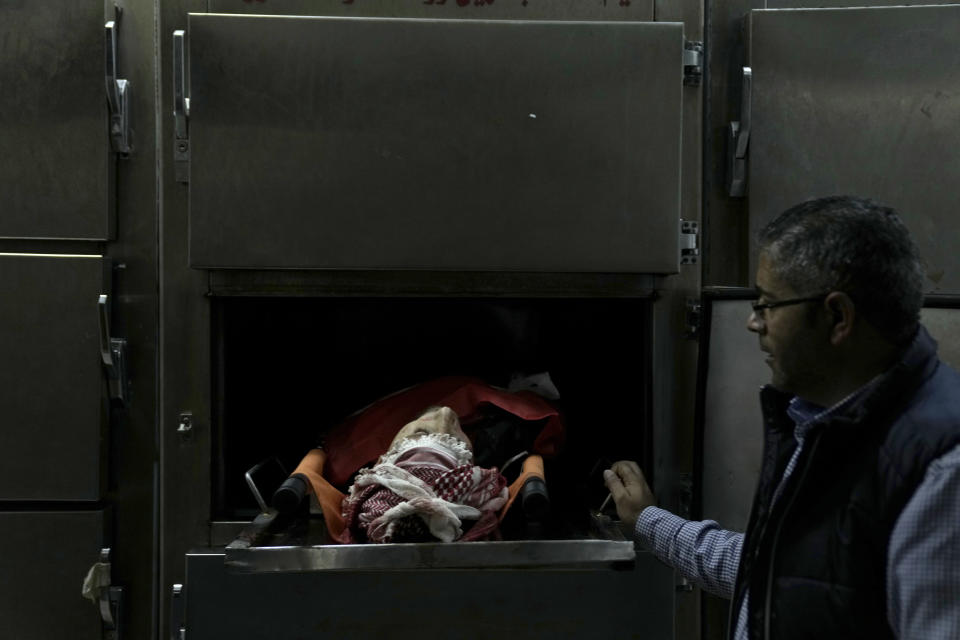 A Palestinian killed in a settler rampage lies in the morgue at the Palestine Medical Complex in the West Bank city of Ramallah, Friday, April 12, 2024. Dozens of Israeli settlers rampaged through a Palestinian village, Palestinian medics and an Israeli rights group said, killing one Palestinian and more than a dozen were wounded. Settlers stormed the village of al-Mughayyir in search of a missing 14-year-old Israeli boy, according to rights group Yesh Din. (AP Photo/Nasser Nasser)