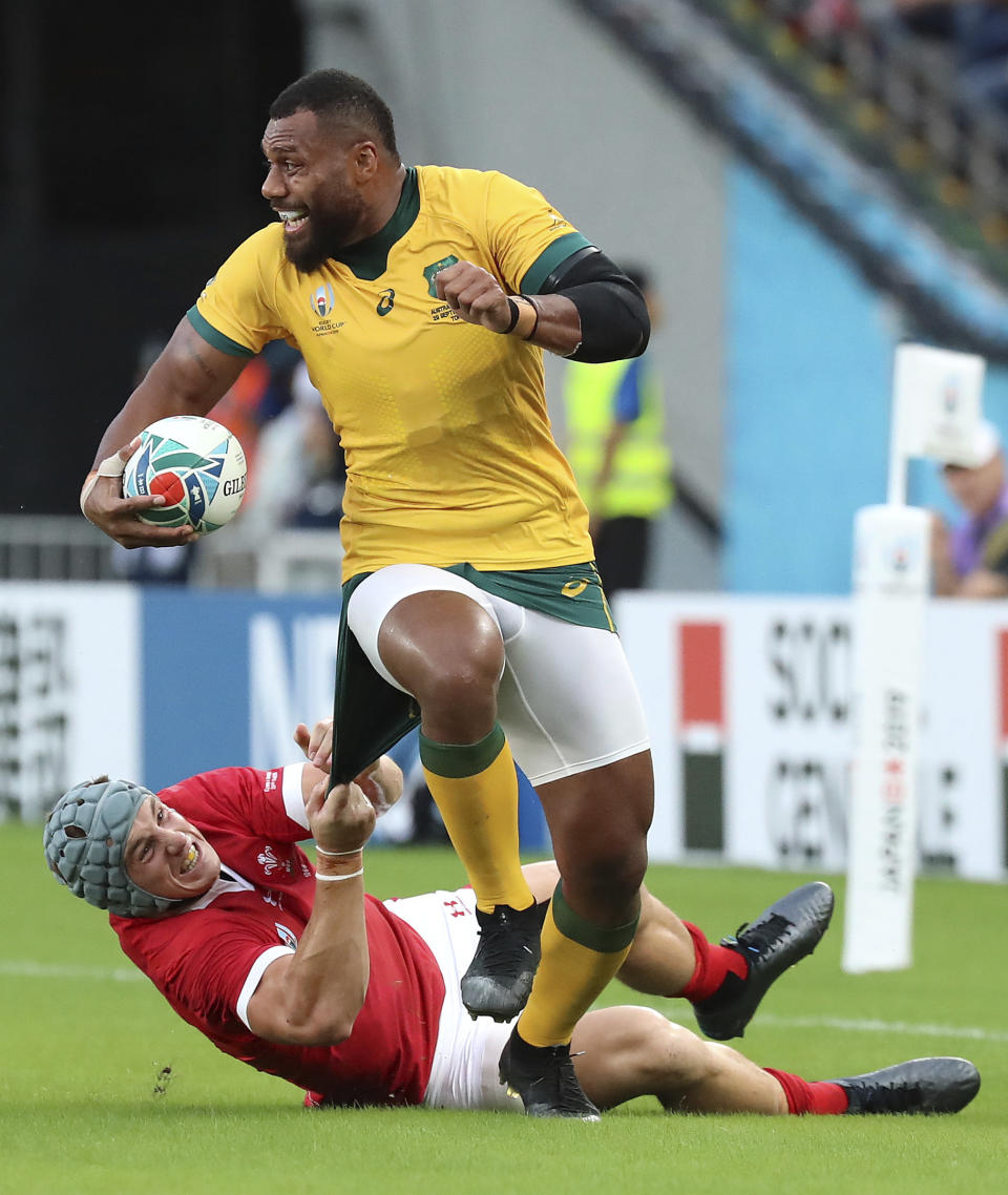 Wales Jonathan Davies attempts to tackle Australia's Samu Kerevi the Rugby World Cup Pool D game at Tokyo Stadium between Australia and Wales in Tokyo, Japan, Sunday, Sept. 29, 2019. (AP Photo/Eugene Hoshiko)