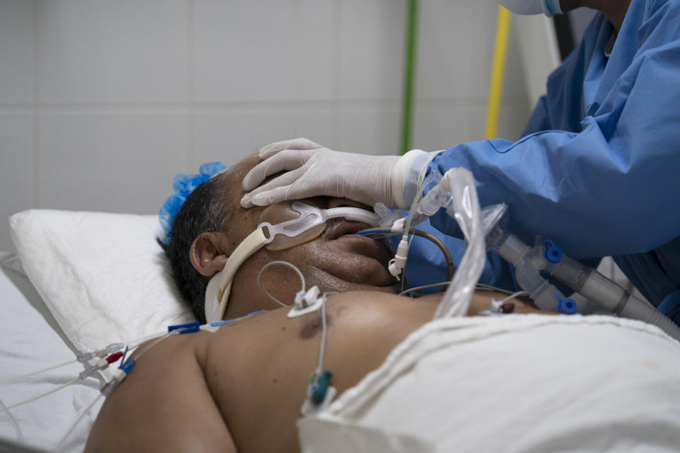 A health worker treats a gravely ill patient at the Ajusco Medio General Hospital which is designated for COVID-19 cases only, in Mexico City, Tuesday, Aug. 31, 2021. (AP Photo/Marco Ugarte)