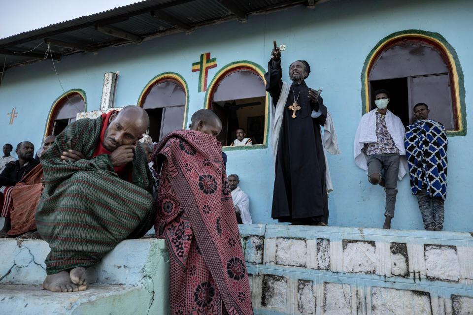 A Tigrayan priest who fled the conflict in Ethiopia's Tigray region, delivers a sermon for Sunday Mass at a church, near Umm Rakouba refugee camp in Qadarif, eastern Sudan, Nov. 29, 2020. (AP Photo/Nariman El-Mofty)