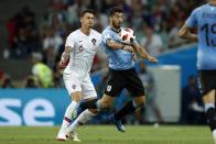 <p>Former West Ham defender, Portugal’s Jose Fonte, challenges Luis Suarez of Uruguay in the first half of the Round of 16 clash </p>