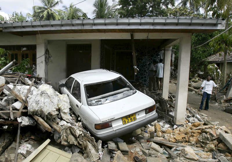 FILE PHOTO: A car is trapped in the wreckage of a collapsed house in the city of Galle