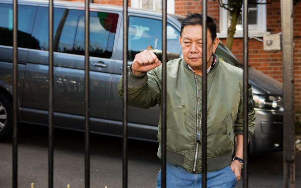 Kyaw Zwar Minn speaks to media through the locked gates of his official residence  - Jamie Lorriman for The Telegraph