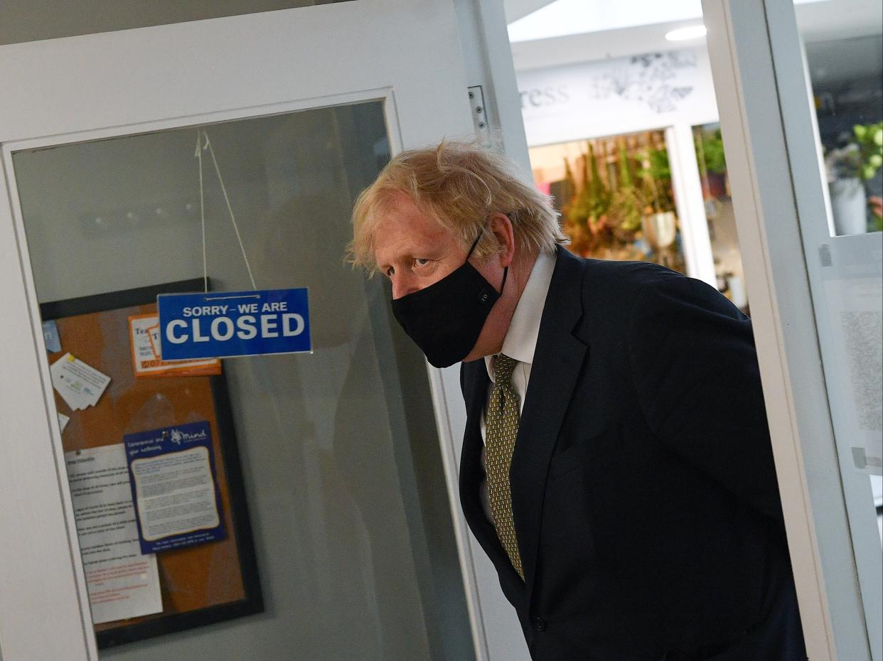 <p>Boris Johnson visits businesses in Truro, England, ahead of the relaxation of restrictions on 12 April</p> (Getty Images)