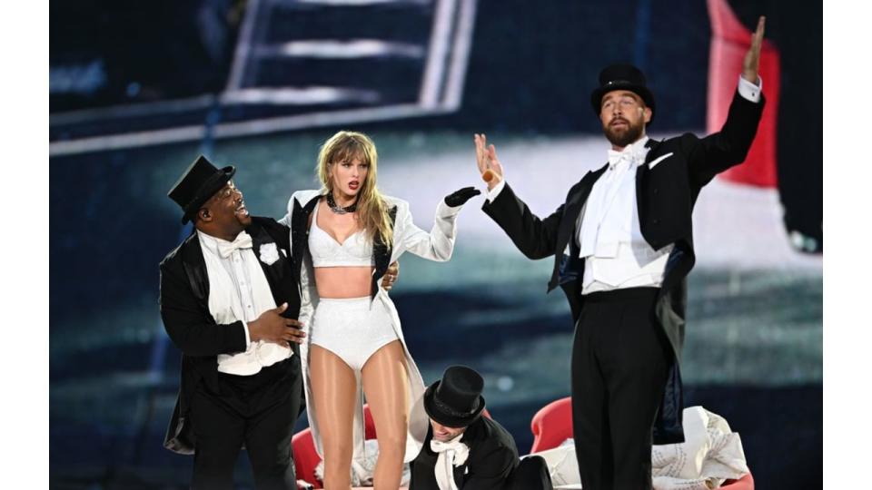 Taylor Swift is joined on stage by Travis Kelce (R), during "Taylor Swift | The Eras Tour" at Wembley Stadium on June 23, 2024 in London, England