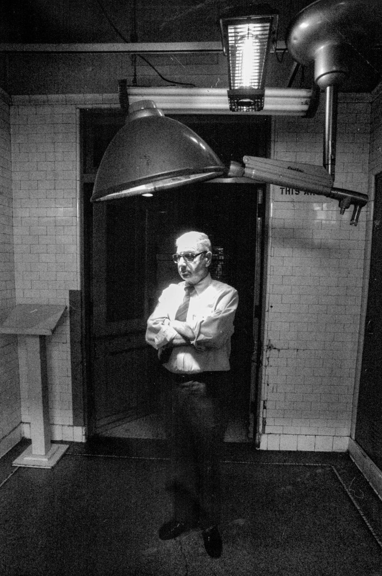 Dr. Werner Spitz stands in the investigation room at the Wayne County Morgue in Detroit in 1988.