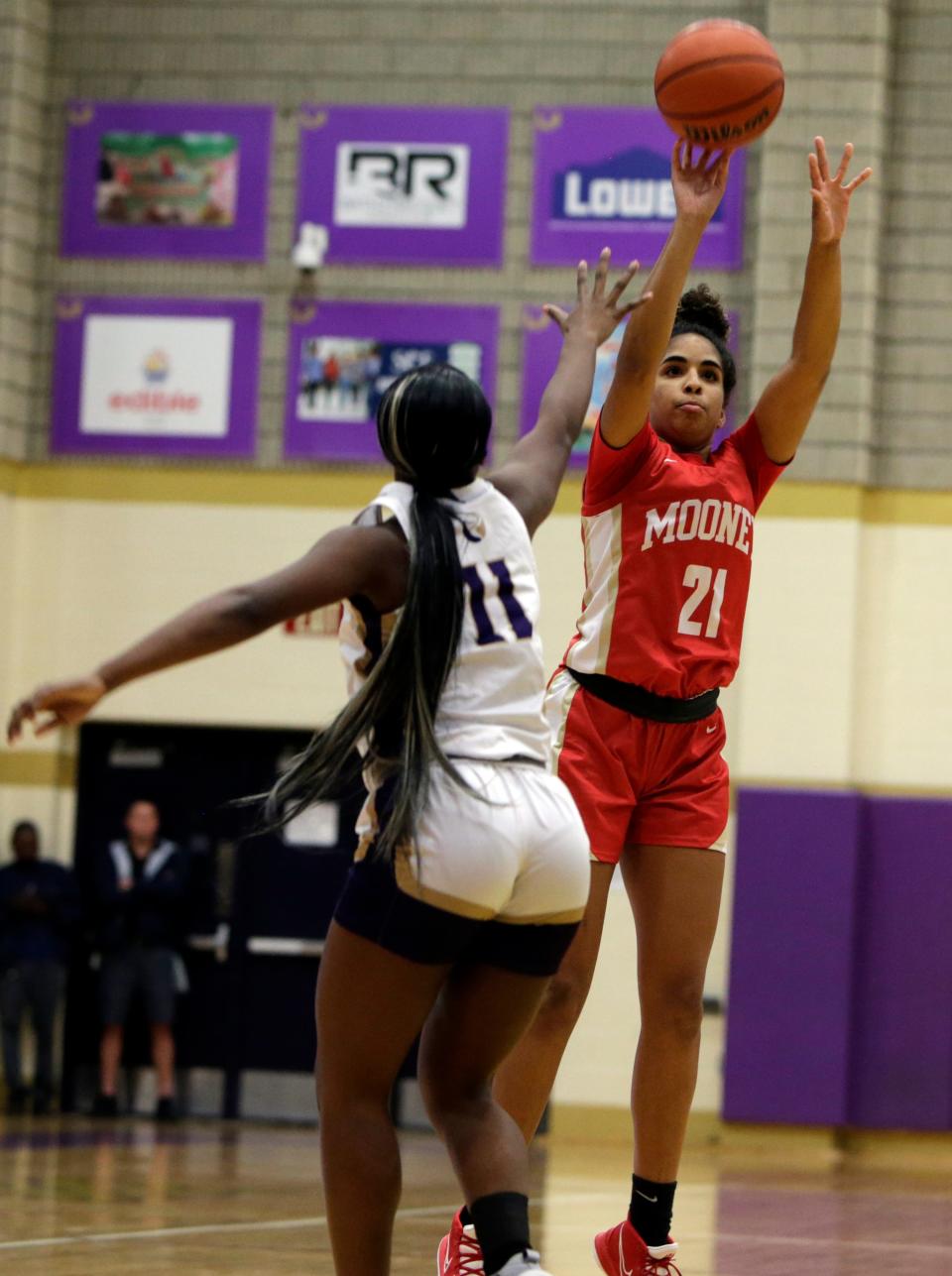 Cardinal Mooney freshman Kali Barrett launches a shot over Booker High's Sariah Bradley during the first quarter of Monday night's MLK Classic at Booker High.