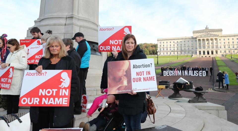 Anti-abortion and pro-choice activists take part in rival demonstrations outside Parliament Buildings at Stormont (PA) (PA Archive)