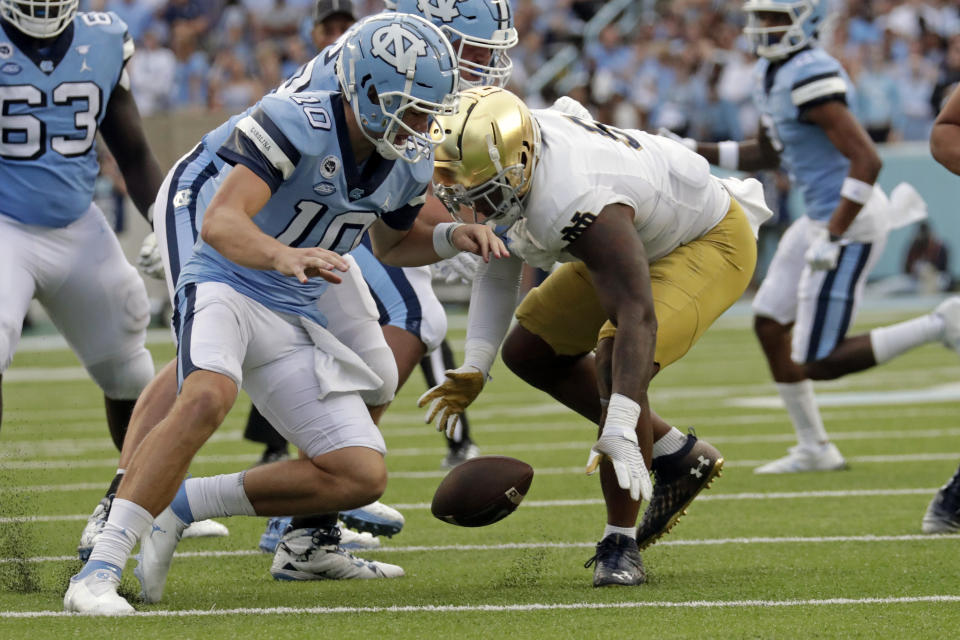 North Carolina quarterback Drake Maye (10) fumbles the ball and Notre Dame defensive lineman Justin Ademilola (9), right, recovers it during the second half of an NCAA college football game in Chapel Hill, N.C., Saturday, Sept. 24, 2022. (AP Photo/Chris Seward)