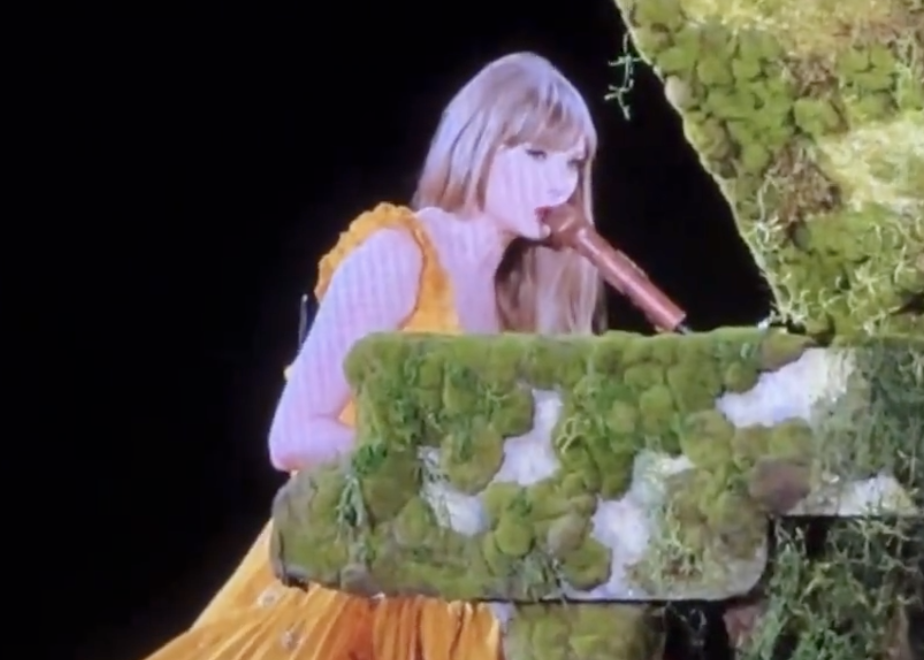 Close-up of Taylor performing onstage at a piano