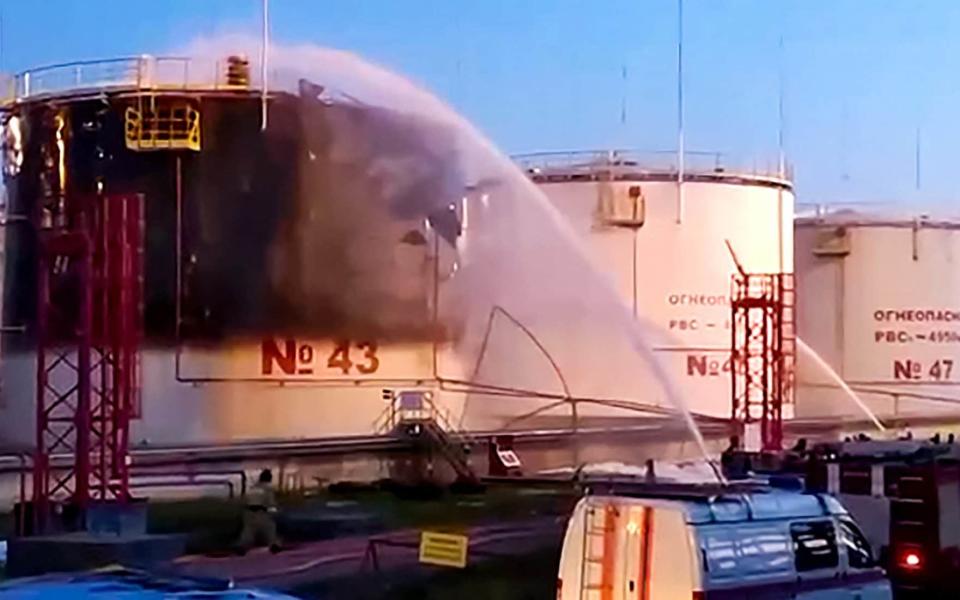 This grab from a handout footage posted on May 4, 2023 on the official Telegram account of Krasnodar Krai governor Veniamin Kondratyev shows firefighters battling a blaze at an oil refinery in the southern Krasnodar region's Ilsky settlement - HANDOUT/AFP