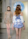 <b>London Fashion Week AW13: Fyodor Golan</b><br><br>A model reveals the back of her drop shouldered blue dress and huge headgear.<br><br>©Rex<b><br></b>