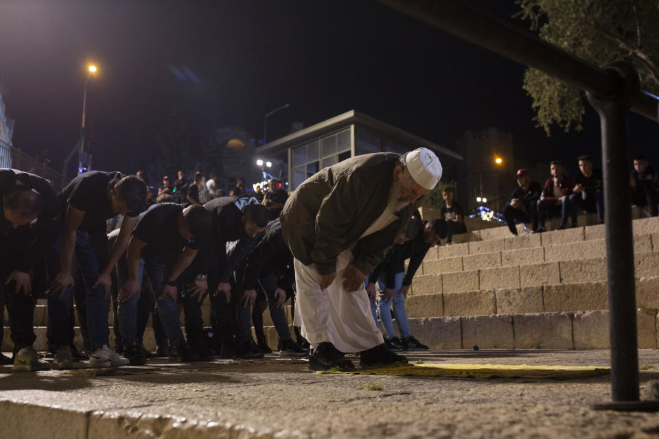 Palestinians pray at the Damascus Gate to the Old City of Jerusalem during the Muslim holy month of Ramadan, Saturday, April 24, 2021. Clashes between police and Palestinian protesters here have become a nightly occurrence throughout the Muslim holy month of Ramadan. (AP Photo/Maya Alleruzzo)
