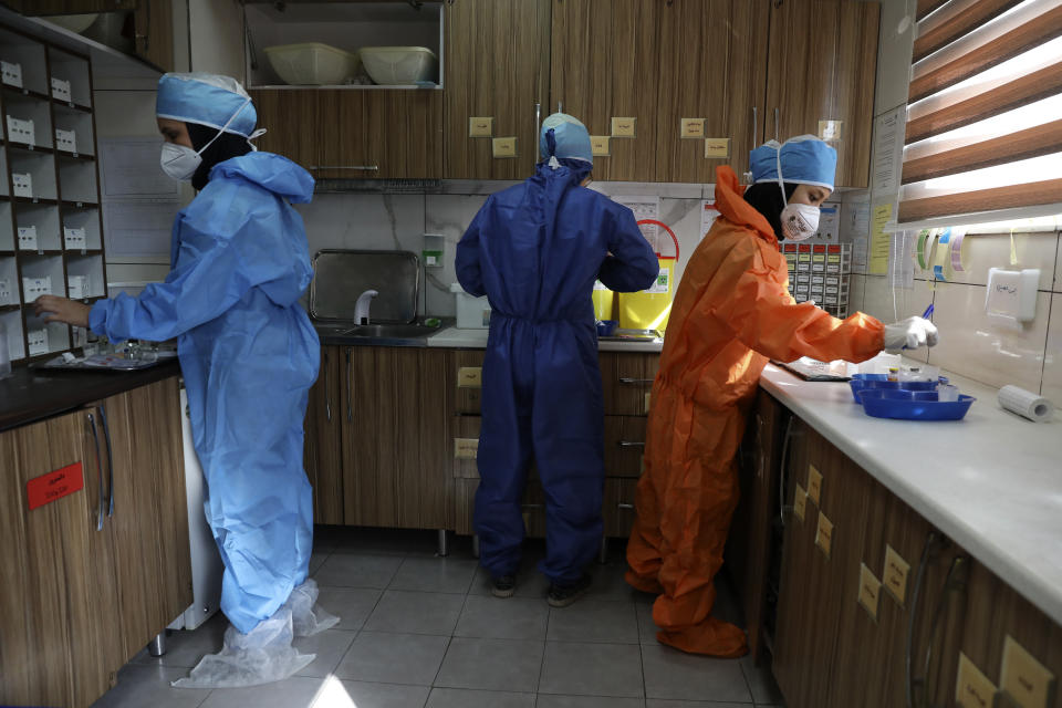 In this Tuesday, June 16, 2020, photo, nurses prepare medicines for COVID-19 patients at the Shohadaye Tajrish Hospital in Tehran, Iran. After months of fighting the coronavirus, Iran only just saw its highest single-day spike in reported cases after Eid al-Fitr, the holiday that celebrates the end of Ramadan. (AP Photo/Vahid Salemi)