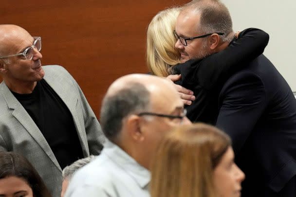 PHOTO: Ryan Petty hugs Annika Dworet, shown with her husband, Mitch Dworet at the Broward County Courthouse in Fort Lauderdale, Oct. 11, 2022. (Amy Beth Bennett/South Florida Sun Sentinel via AP, POOL)