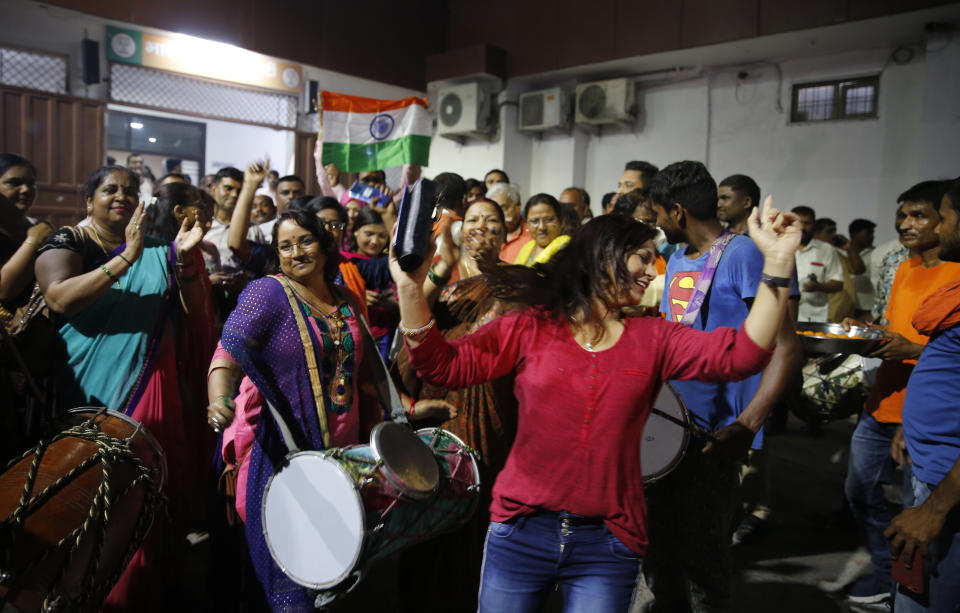 Supporters of India's ruling Bharatiya Janata Party (BJP) celebrate the government revoking Kashmir's special status, in Lucknow, India, Tuesday, Aug. 6, 2019. Indian lawmakers passed a bill Tuesday that strips the statehood from the Indian-administered portion of Muslim-majority Kashmir amid an indefinite security lockdown in the disputed Himalayan territory, actions that neighboring Pakistan warned could lead to war. (AP Photo/Rajesh Kumar Singh)
