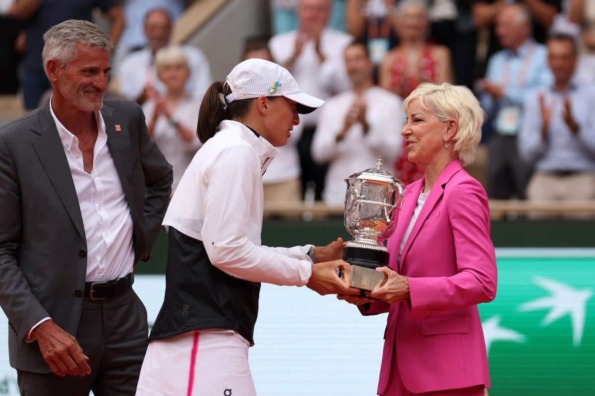 Swiatek receives the trophy from Chris Evert, who said the 22-year-old could threaten her French Open record (Getty Images)