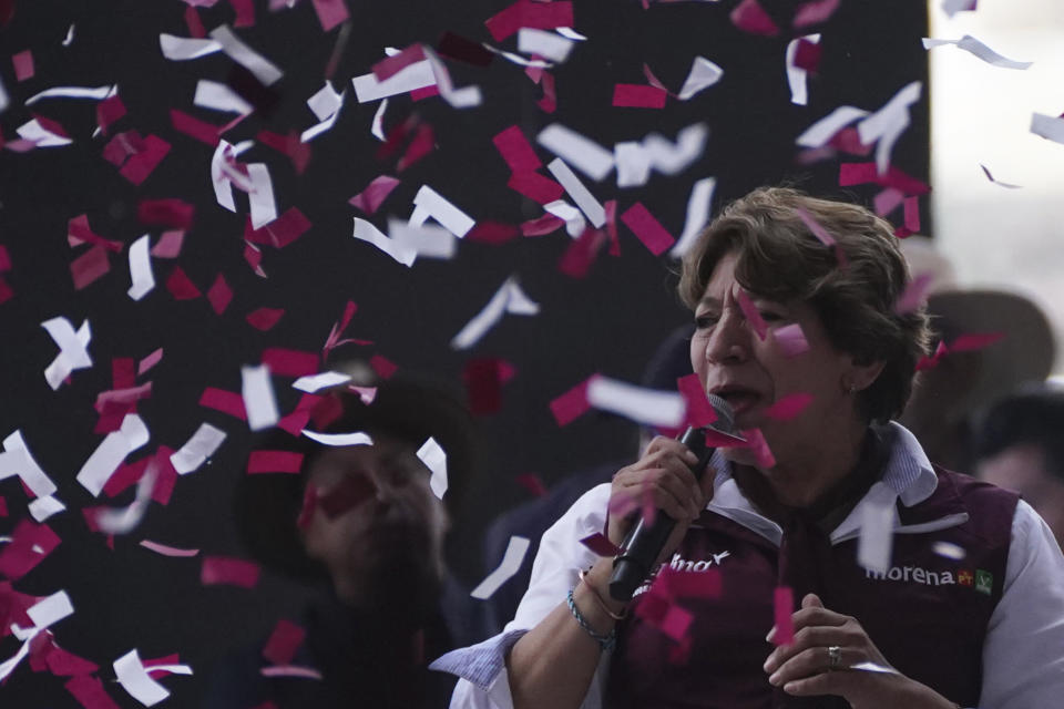 Delfina Gomez, left, MORENA political party gubernatorial candidate, speaks to the crowd during a campaign rally in Valle de Chalco, Mexico, Sunday, May 28, 2023. Voters in the state of Mexico go to the polls on June 4 to elect a new governor. (AP Photo/Marco Ugarte)