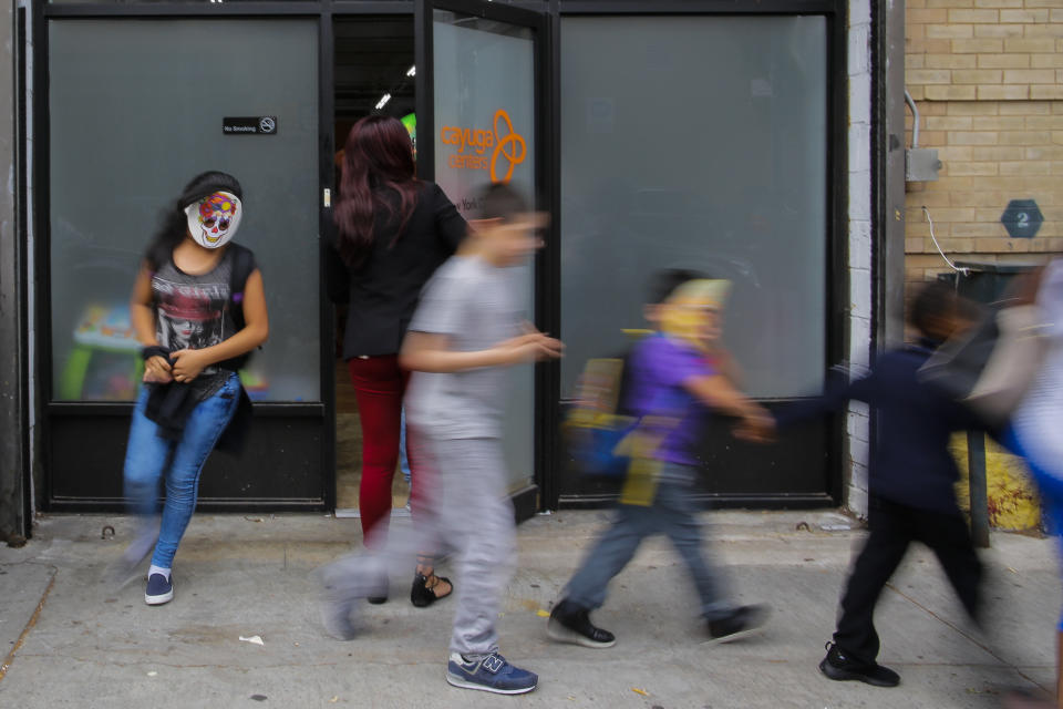 Children with masks exit the Cayuga Centers branch on June 22 in Harlem, New York. The youngest migrant at&nbsp;Cayuga is 9 months old. (Photo: VIEW press via Getty Images)