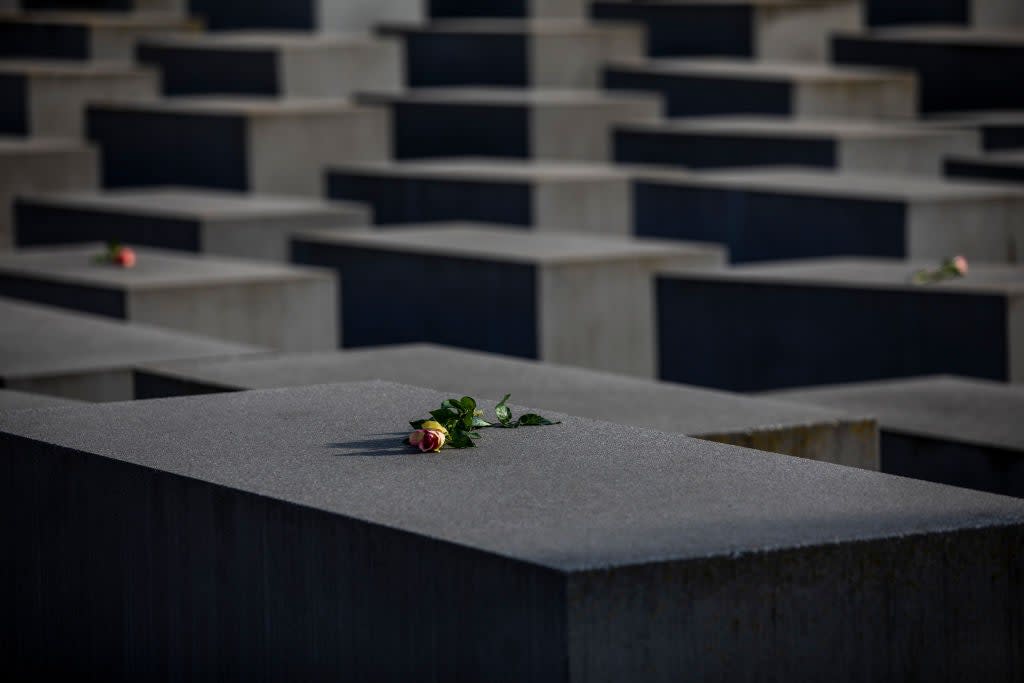 <p>Roses are placed on the Holocaust Memorial on International Holocaust Remembrance Day, 2021, in Berlin, Germany. Today marks the 76th anniversary of the liberation of the Auschwitz</p> (Getty Images)