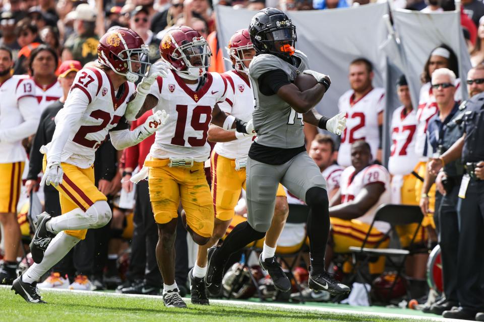 Colorado Buffaloes wide receiver Omarion Miller (14) runs the ball past USC Trojans defenders at Folsom Field on Sept. 30, 2023, in Boulder. Mandatory Credit: Chet Strange-USA TODAY Sports