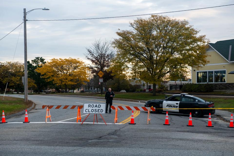 Police barricade a road that leads to the scene where multiple people were killed in Lewiston, Maine, on Oct. 25, 2023.