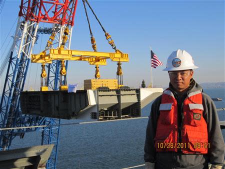 Philip He is seen working as an engineer for the California state transportation agency on a Bay Bridge renovation project in a family handout picture taken in October 2011 and provided to Reuters in December 2013. REUTERS/Family Photo/Handout