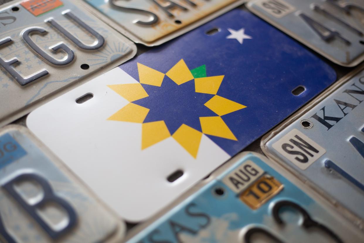 A city of Topeka flag license plate is seen with a mix of current and older Kansas license plates.