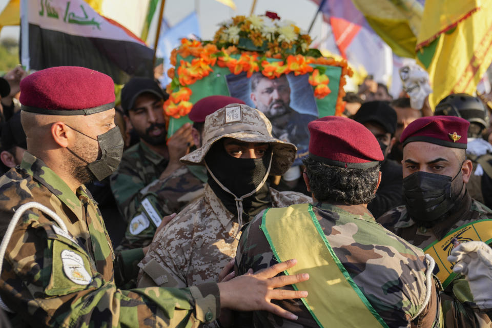 Fighters from the Popular Mobilization Forces, carry the coffin of a commander from the Kataib Hezbollah paramilitary group, Wissam Muhammad Sabir Al-Saadi, known as Abu Baqir Al-Saadi, who was killed in a U.S. airstrike, in Baghdad, Iraq, Thursday, Feb. 8, 2024. The U.S. military says a U.S. drone strike blew up a car in the Iraqi capital Wednesday night, killing the high-ranking commander.(AP Photo/Hadi Mizban)