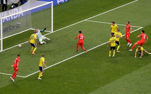 England's Harry Maguire, right, scores the opening goal during the quarterfinal match between Sweden and England at the 2018 soccer World Cup in the Samara Arena, in Samara, Russia, Saturday, July 7, 2018 - Credit: AP