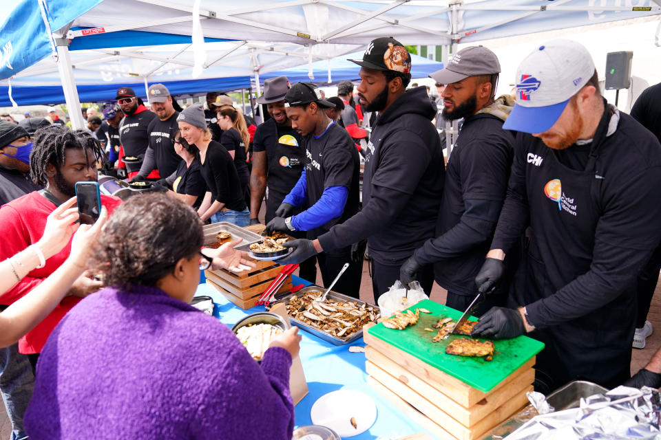 Buffalo Bills players serve food at a World Central Kitchen tent near the scene of Saturday's shooting at a supermarket, in Buffalo, N.Y., Wednesday, May 18, 2022. (AP Photo/Matt Rourke)