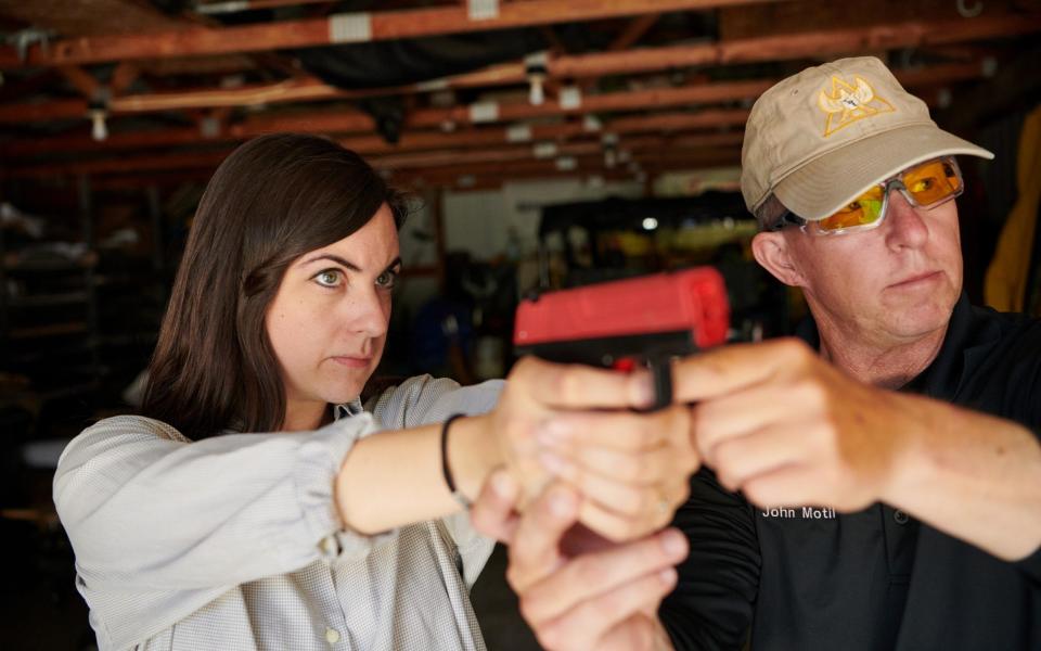 Telegraph journalist Josie Ensor practices her sighting with Tactical Defense Institute instructor John Motil. - Stephen Takacs