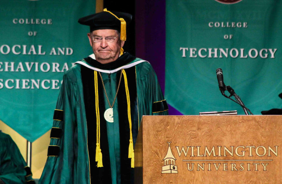 Wilmington University Board of Trustees member Irénée du Pont Jr. stands in recognition during Wilmington University commencement exercise for the College of Arts & Sciences and College of Business.