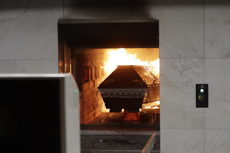 A casket is incinerated at a crematorium in Ostrava, Czech Republic, Thursday, Jan. 7, 2021. The biggest crematorium in the Czech Republic has been overwhelmed by mounting numbers of pandemic victims. With new confirmed COVID-19 infections around record highs, the situation looks set to worsen. Authorities in the northeastern city of Ostrava have been speeding up plans to build a fourth furnace but, in the meantime, have sought help from the government’s central crisis committee for pandemic coordination. (AP Photo/Petr David Josek)