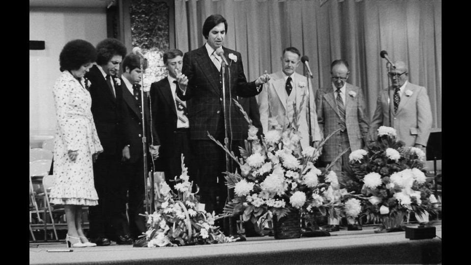 Rev. David and Meralene Lombardi (left) listen as the late Bishop C. Herschel Gammill (center) prays at the dedication of Trinity Gospel Temple in Canton in 1976. The church bought the former department store in 1975.
(Credit: Courtesy of Rev. Dana Gammill)