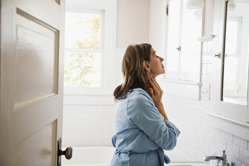 woman looking in mirror