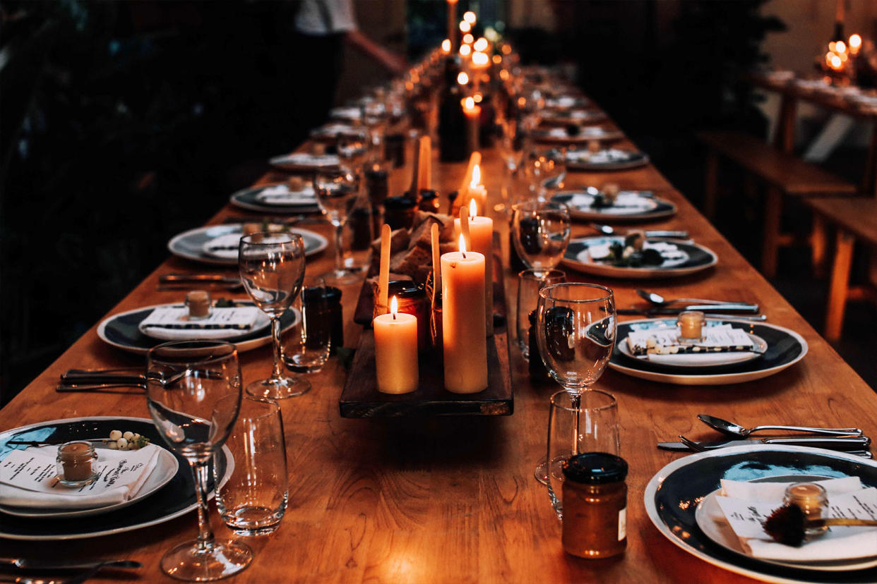 Lit candles on a set dining table Getty Images/i_capturemoments/500px