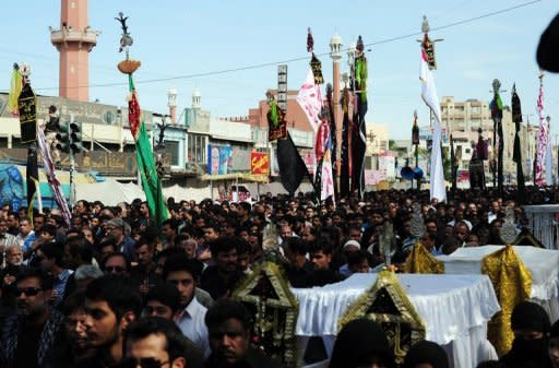 Shiite Muslims take part in a religious procession on the ninth day of holy month of Moharram in Karachi on Saturday. The attack on Shiites, a minority in Sunni-dominated Pakistan, came as they marched to mourn Prophet Mohammed's grandson Imam Hussain during Muharram which culminates Sunday in Ashura, the group's holiest day of the year