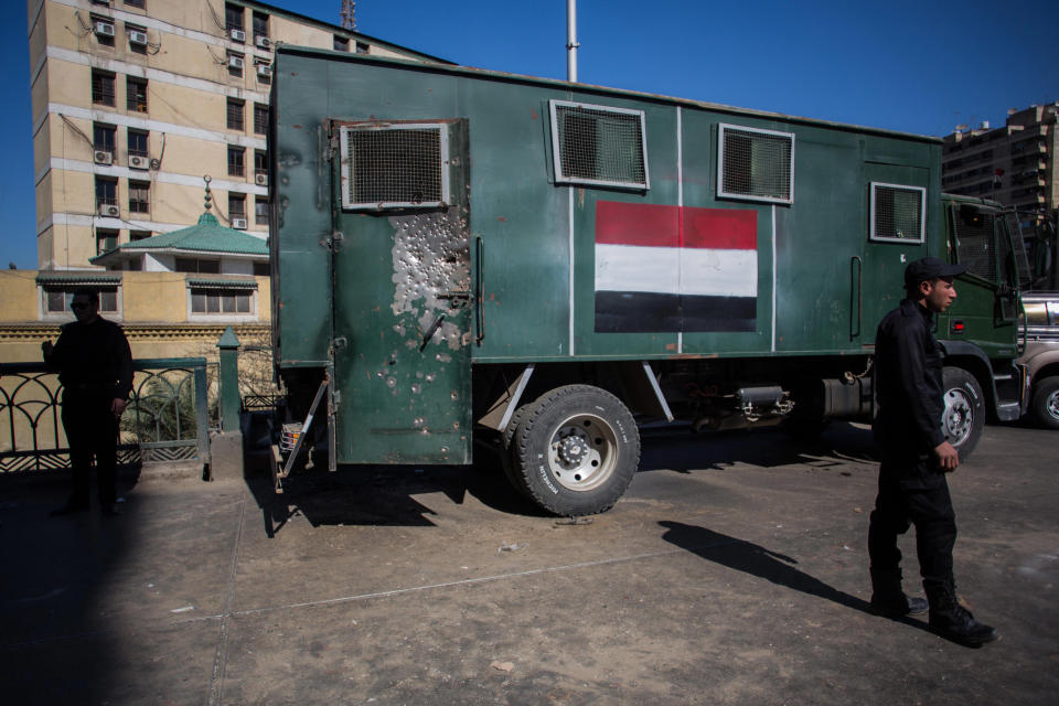 Egyptian police officers stand guard at the site of bomb explosions targeted at a checkpoint in Giza, Egypt, Friday, Feb. 7, 2014. Twin homemade bombs targeting a police checkpoint wounded several people on a bridge in Cairo's twin city of Giza Friday morning, the latest apparent attack by militants near the center of the Egyptian capital. (AP Photo/Eman Helal)