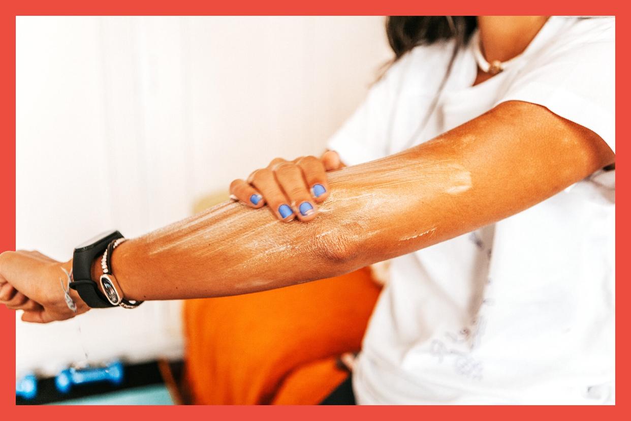 Woman applying sunscreen on her arm