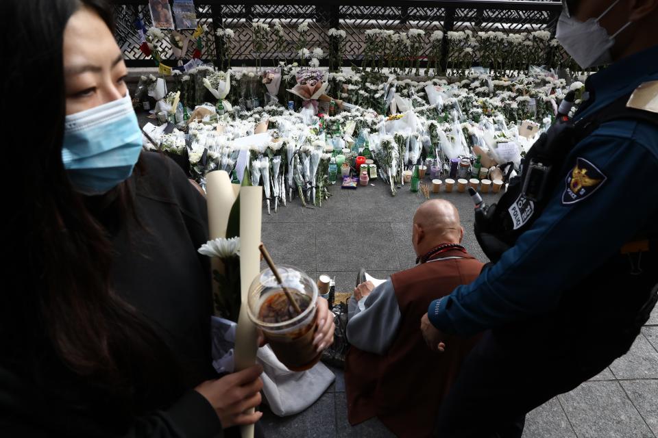 Monks pay tribute for the victims of the Halloween celebration stampede, on the street near the scene on 31 October 2022 in Seoul, South Korea (Getty Images)