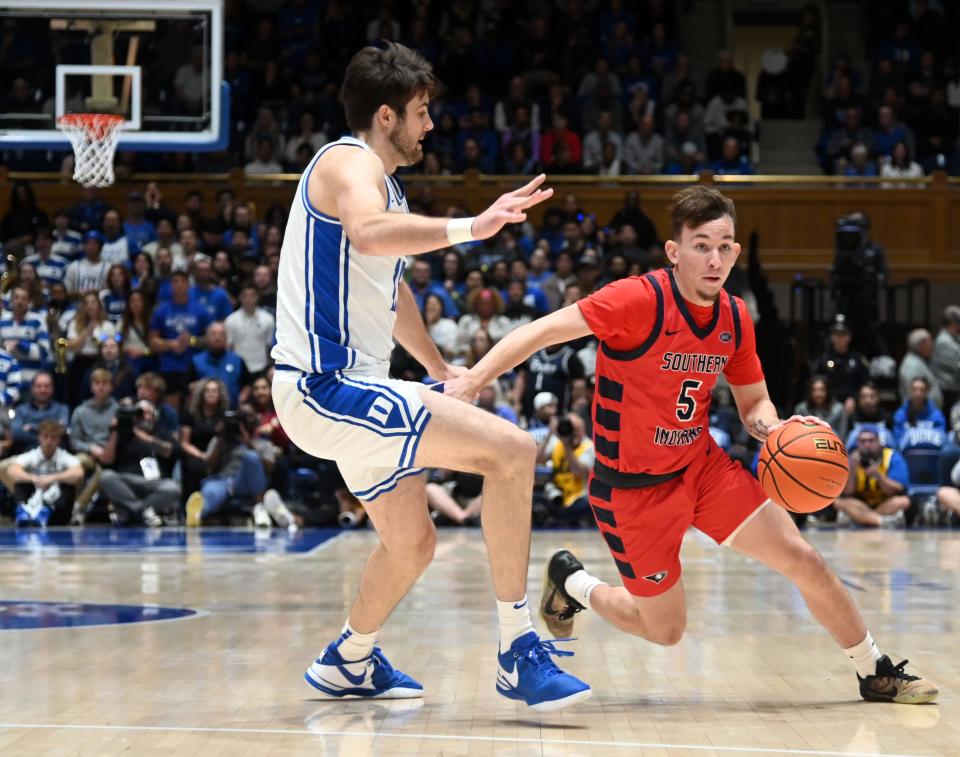 Nov 24, 2023; Durham, North Carolina, USA; Southern Indiana Screaming Eagles guard Jack Campion (5) controls the ball in front of Duke Blue Devils center Ryan Young (15)during the first half at Cameron Indoor Stadium. Mandatory Credit: Rob Kinnan-USA TODAY Sports