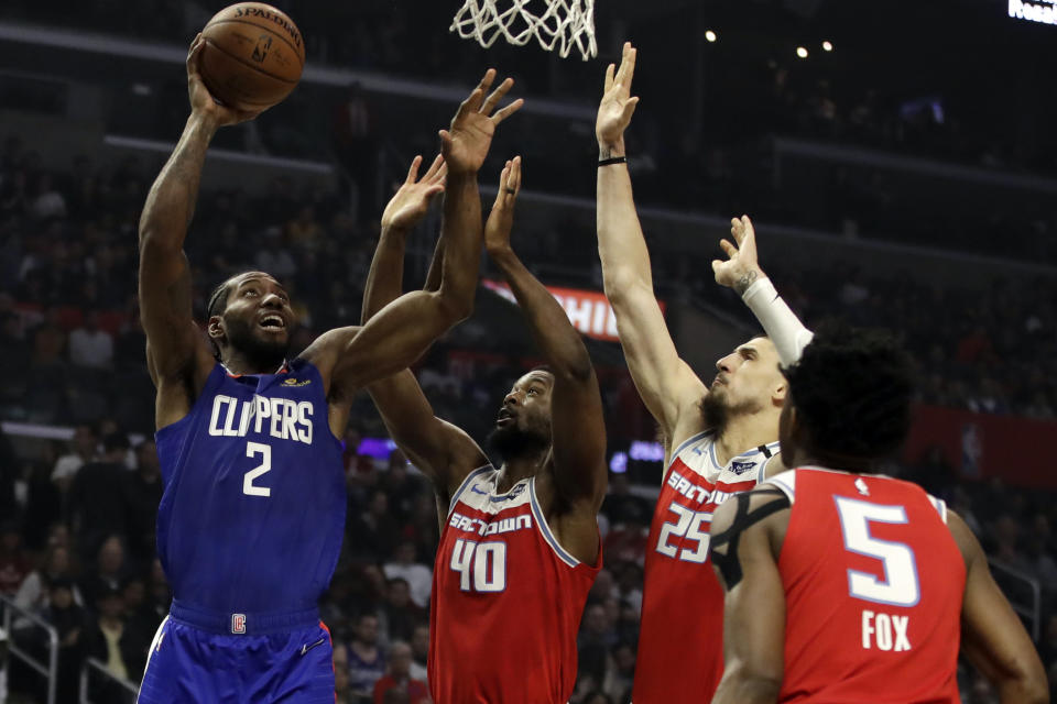 Los Angeles Clippers' Kawhi Leonard (2) shoots over Sacramento Kings' Harrison Barnes (40) during the first half of an NBA basketball game Saturday, Feb. 22, 2020, in Los Angeles. (AP Photo/Marcio Jose Sanchez)