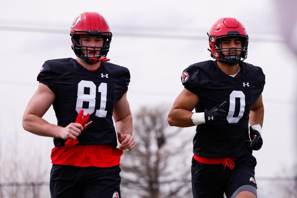 Utah defensive ends Connor O’Toole, left, and Logan Fano jog on the field during spring camp at the University of Utah in Salt Lake City. | Hunter Dyke, University of Utah Athletics